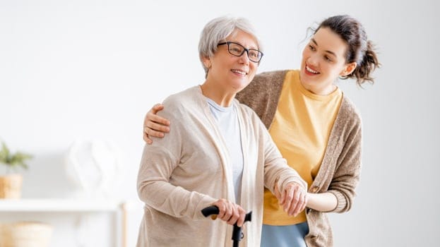 People loading canned food into a box.