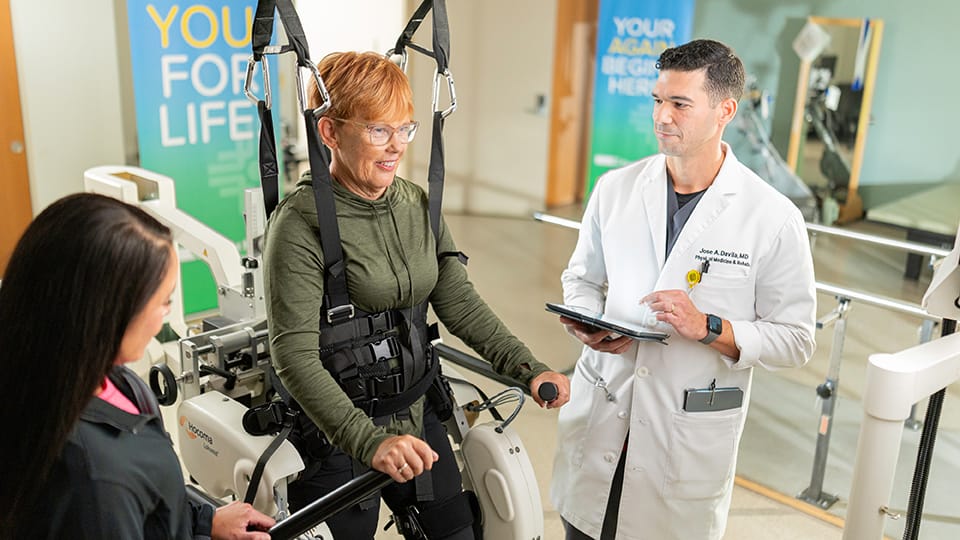 Woman who had a stroke using Lokomat to relearn how to walk.