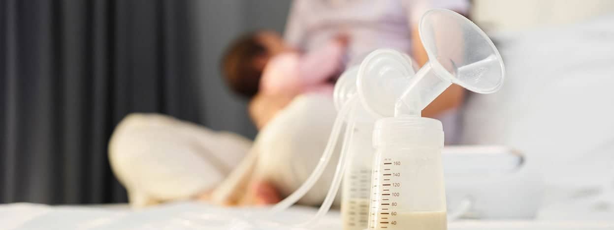 Bottle with breastfeeding cup attached