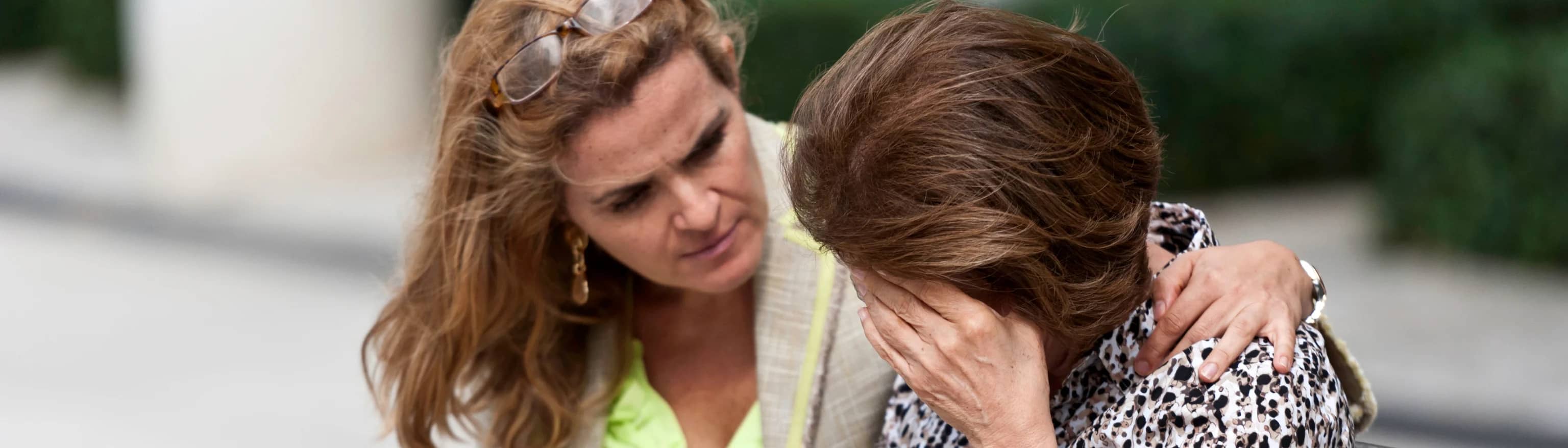 One woman comforting a crying woman