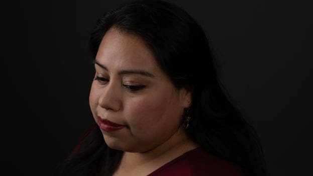 Hispanic woman looking down