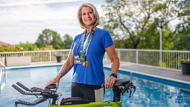 Woman standing next to a stationary bike