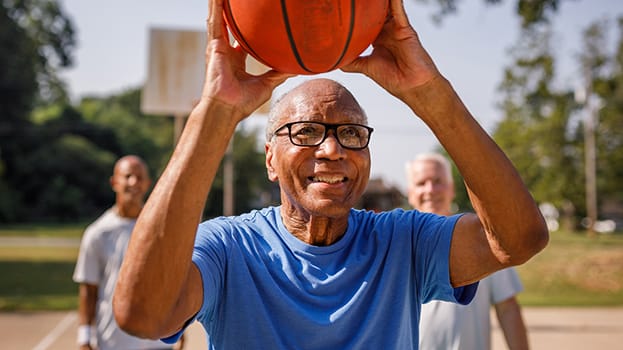 Senior man playing basketball